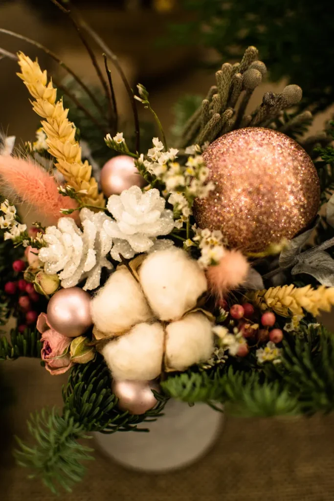 A gorgeous floral arrangement with some glittery ornaments included.