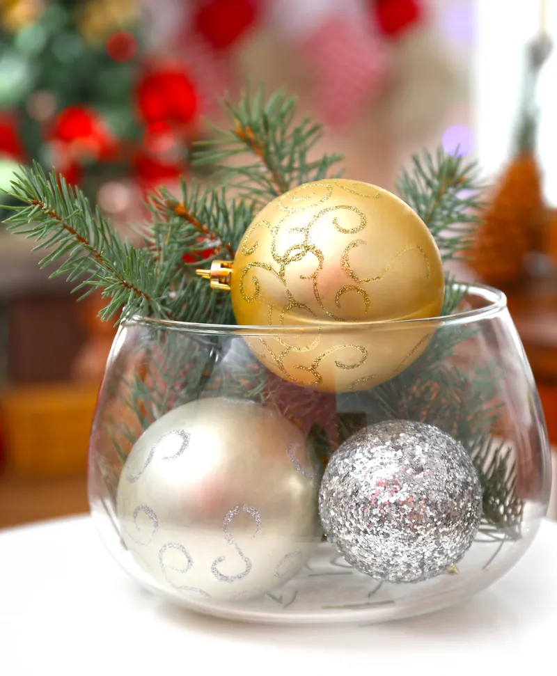 Vases filled with ornaments for centerpieces.