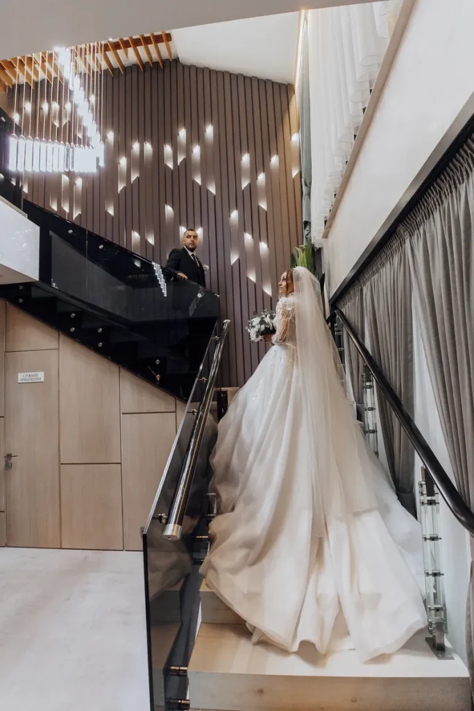 A modern loft space for a wedding with a couple on the stairs.