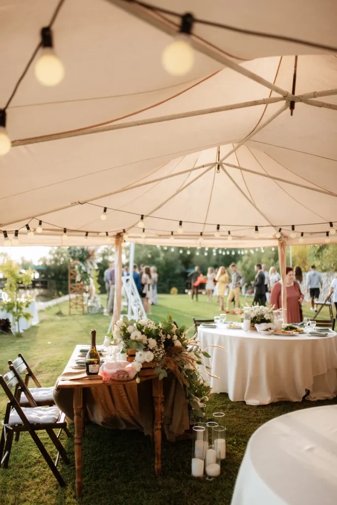 A tent covering a beautiful garden wedding.