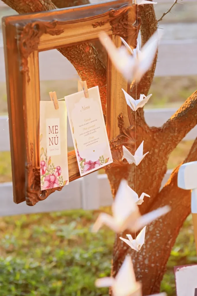 An example of ways to hang things from trees, and while this photo doesn't include polaroids, you can easily see how you'd swap the menu's for them.