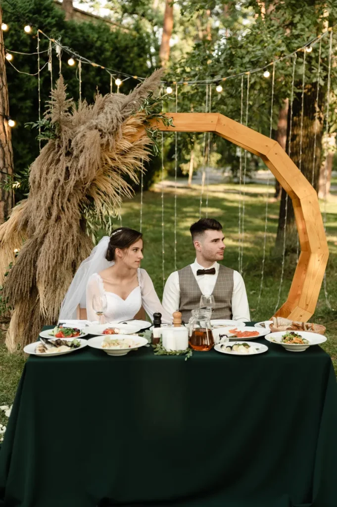 A married couple sitting at their sweetheart table.