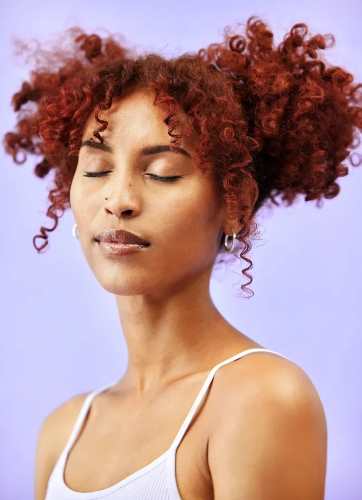 Natural curly hair in pigtails that makes a natural boho feel.