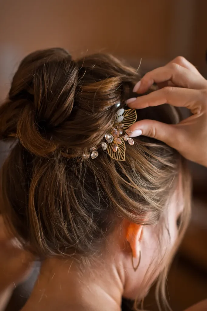 A delicate hair pin holding up a boho bun.