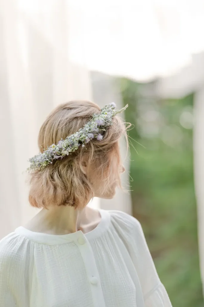 A shower hairstyle with a boho flower wreath.
