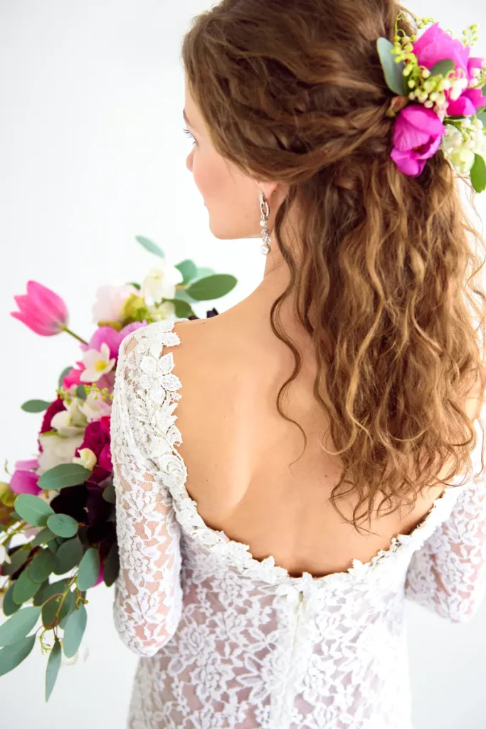 Loose waves with real flowers in the brides hair.