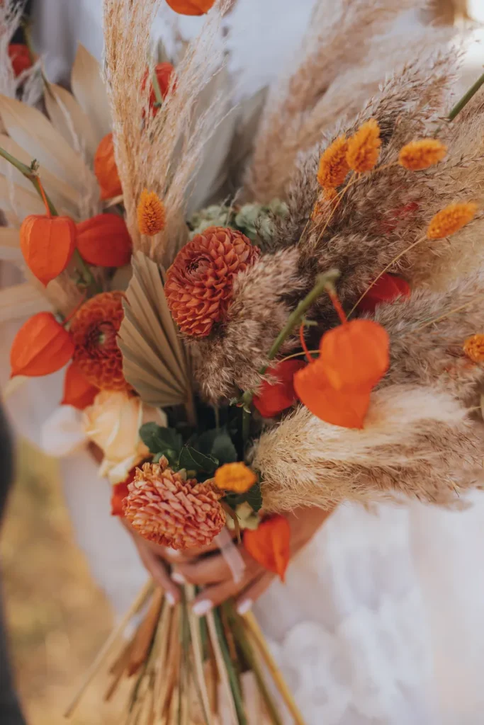 A boho bridal bouquet for fall with dried grass and lovely bell flowers.