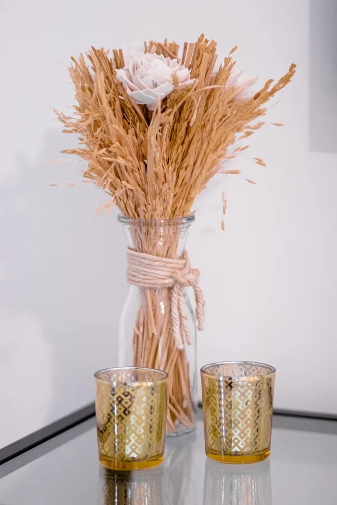 fall boho wedding centerpieces with vases wrapped with twine.