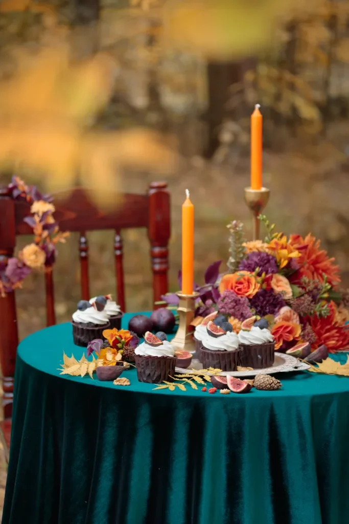 A fun rustic fall wedding centerpiece with fall inspired flowers and cupcakes.