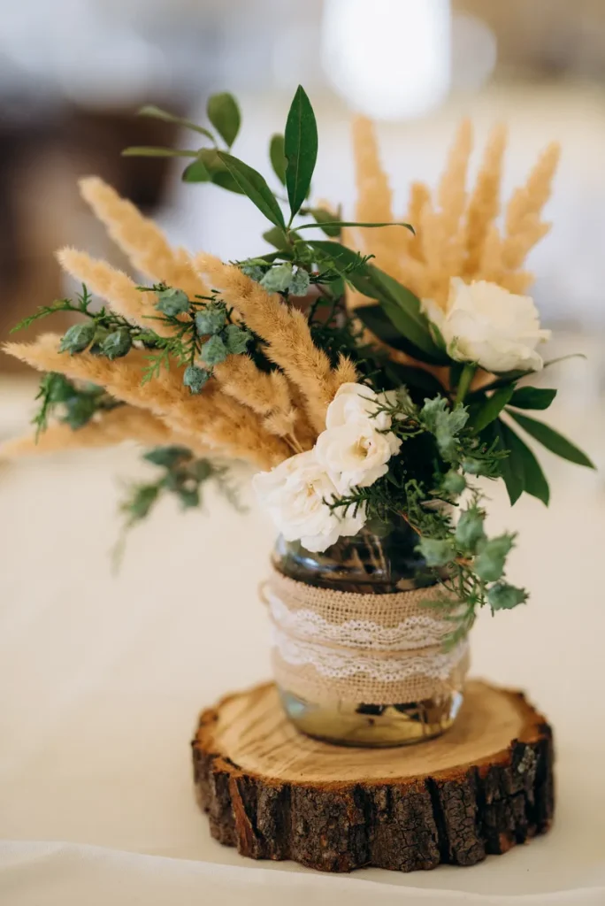 mason jar rustic centerpieces with a wood slice underneath