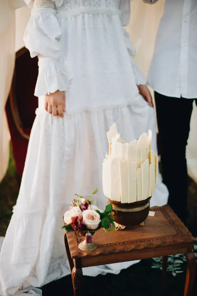 An elegant bohemian wedding cake with white chocolate shards.