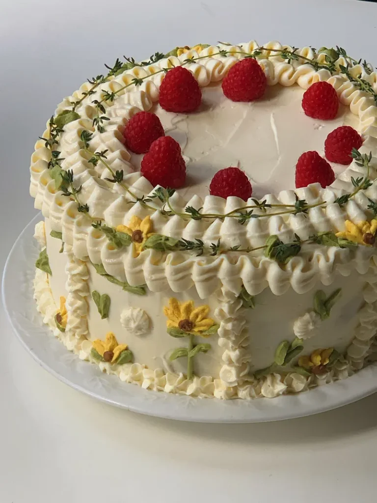 A vintage inspired bohemian wedding cake with traditional old-school piping and sunflower motifs.