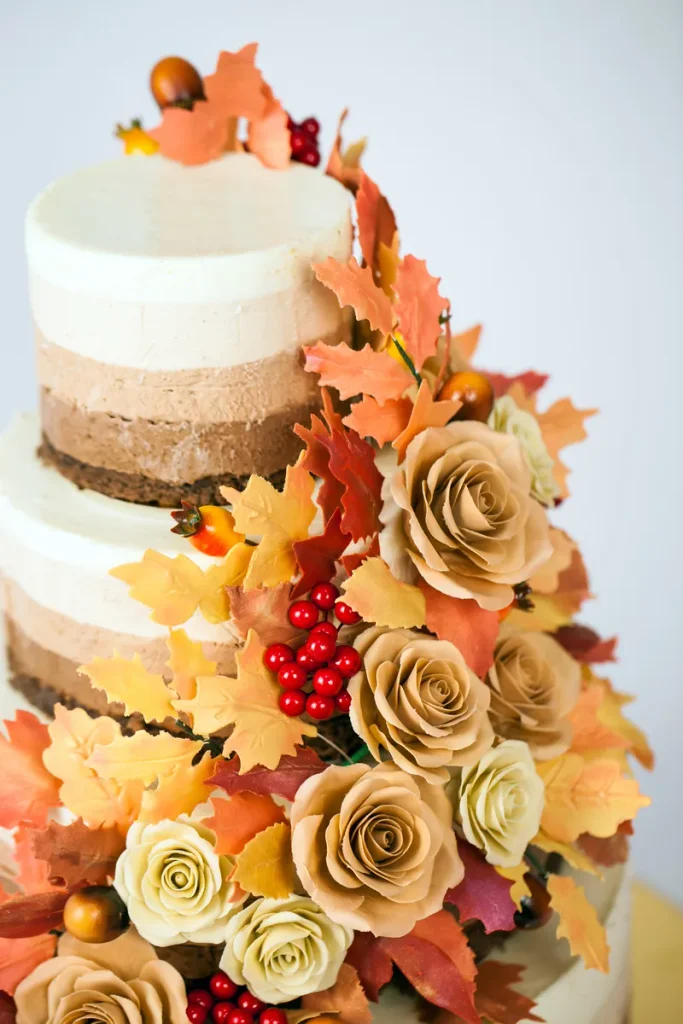 A fall wedding cake featuring fall foliage.