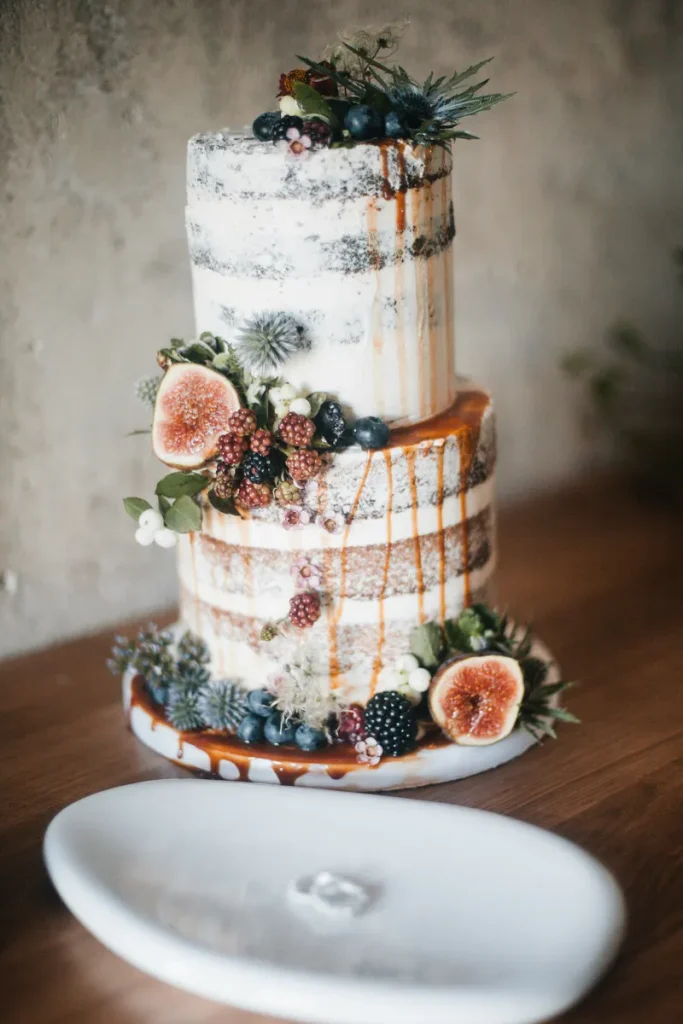 A fall wedding cake with fruit.