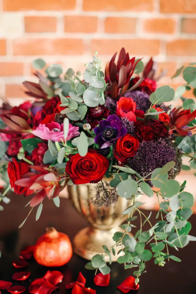 A picture showing how moody jewel toned flowers can really set the stage in your fall wedding flowers.