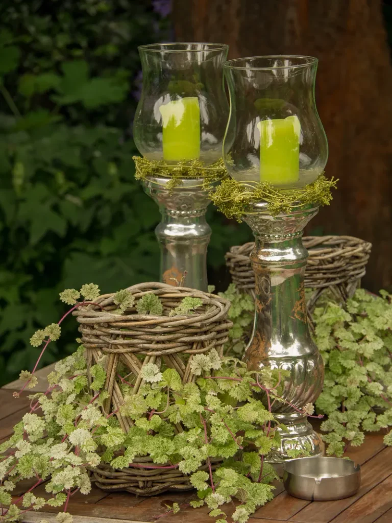 Some centerpieces featuring greenery that you can use for your forest wedding table decor.