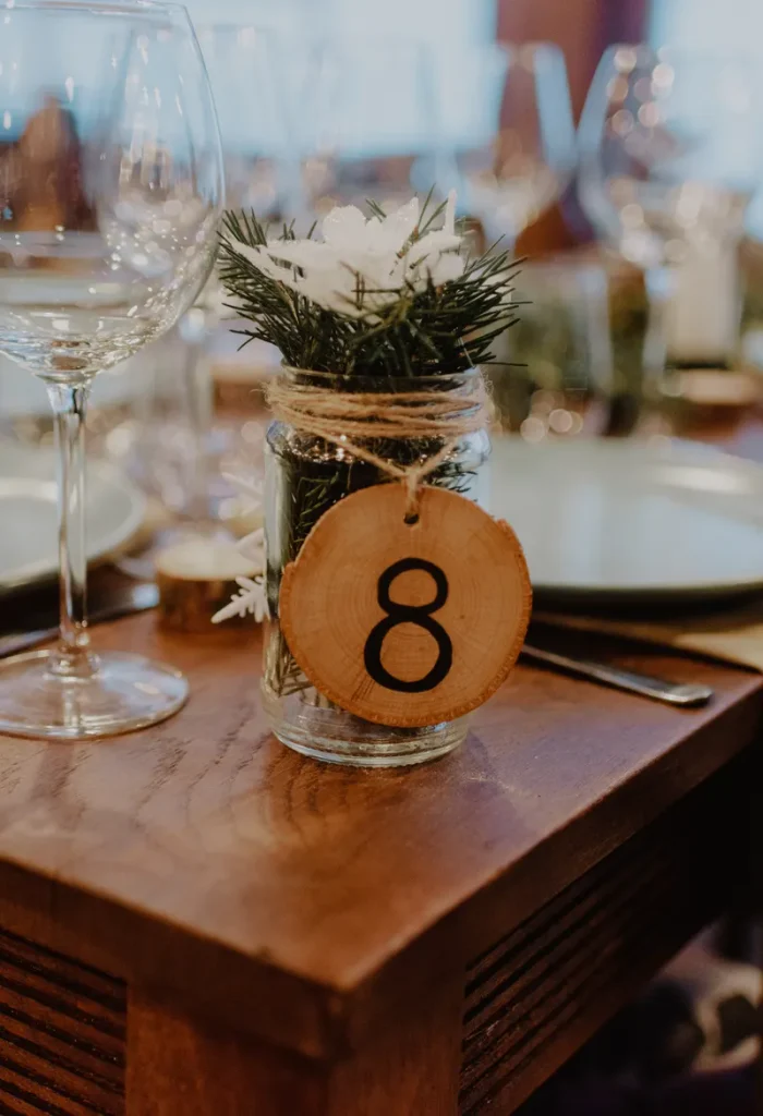 A table number on a tiny wood slice that you could use for your forest wedding table decor.