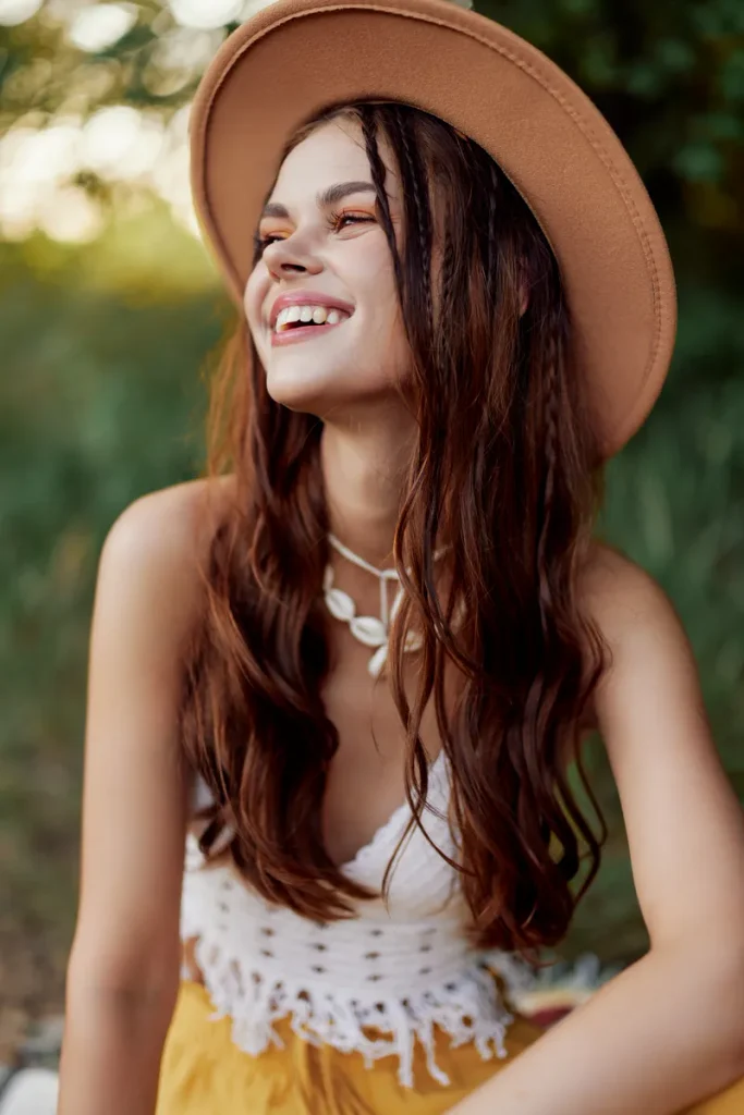 A picture of a long haired girl with little braids sprinkled throughout, that could be a casual look for bohemian wedding hair.