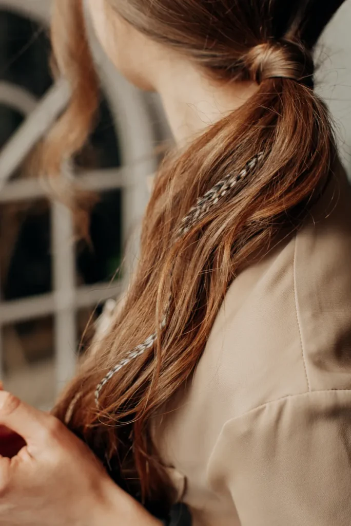 A ponytail featuring some thing feathers peppered throughout that you could use for your bohemian wedding hair.