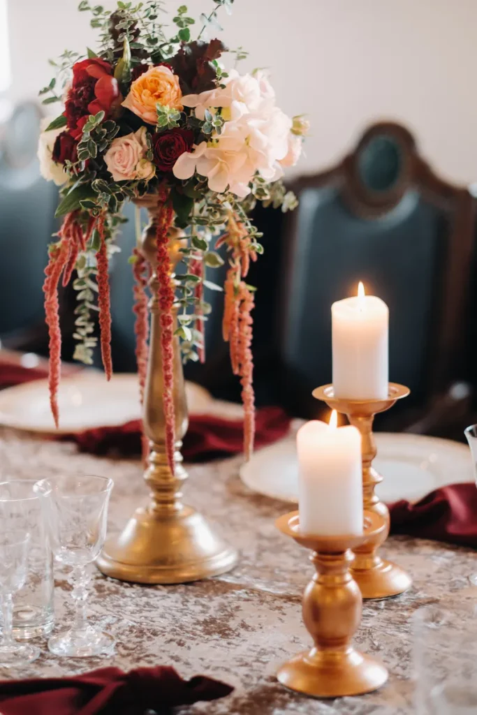 Romantic fall wedding centerpieces lit by candlelight.
